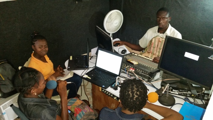 Some of the helpers and students at the computer school, running a segment on the Internet radio station in the room at the back of the computer classroom