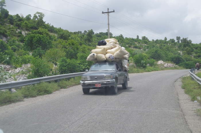 Annoying that the photo came out a bit blurry, but Haitian vehicles consistently continue to explore new vehicular frontiers of what is denoted by "overloaded"