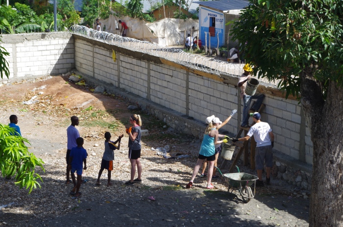 Haitians and Americans working making a concerted combined effort to make the razor wire a reality